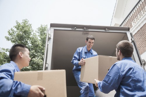 Moving team handling furniture safely during a Lambeth man and van service